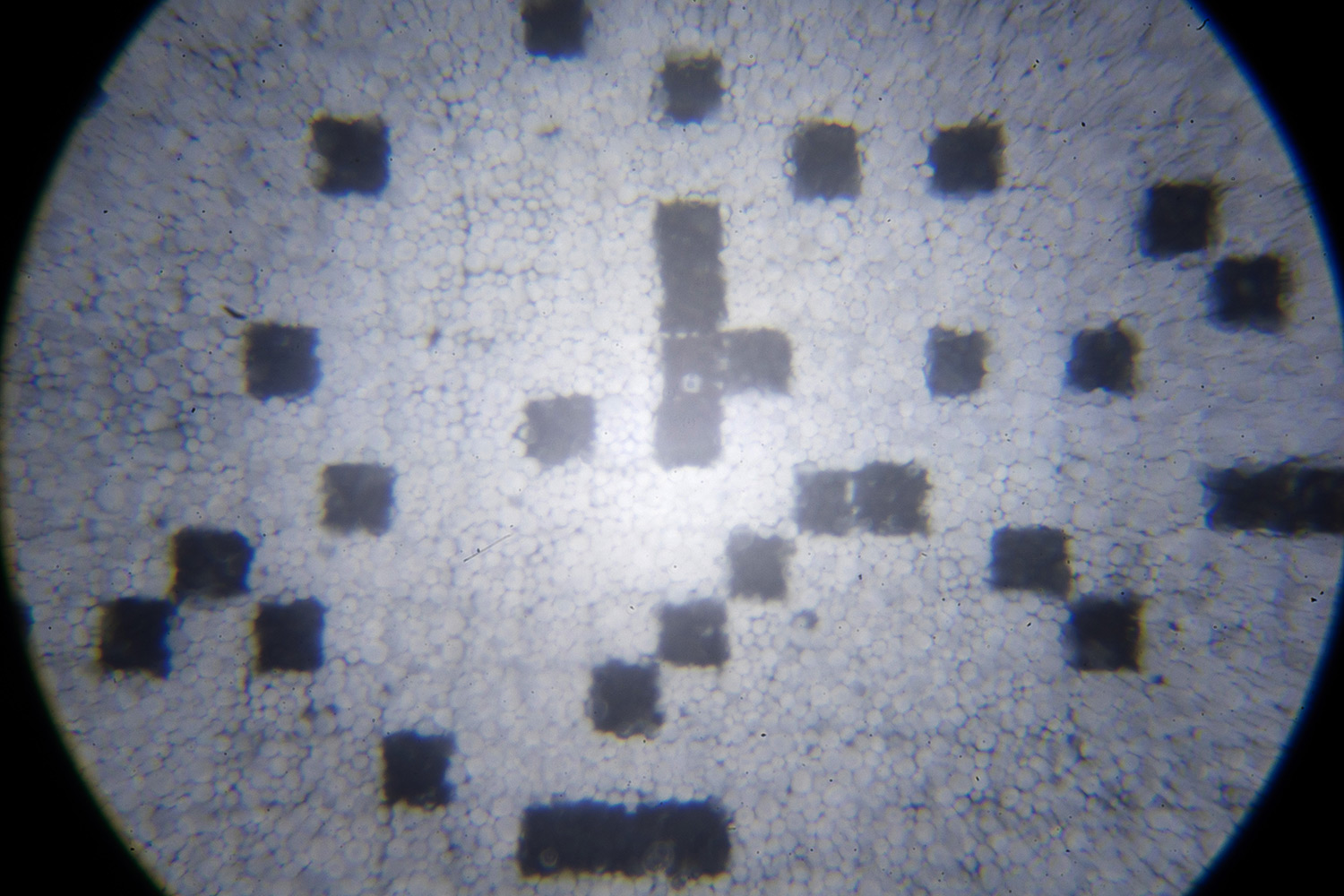 microscopic view of e-ink screen revealing black and white pixels consisting of multiple irregular small spheres