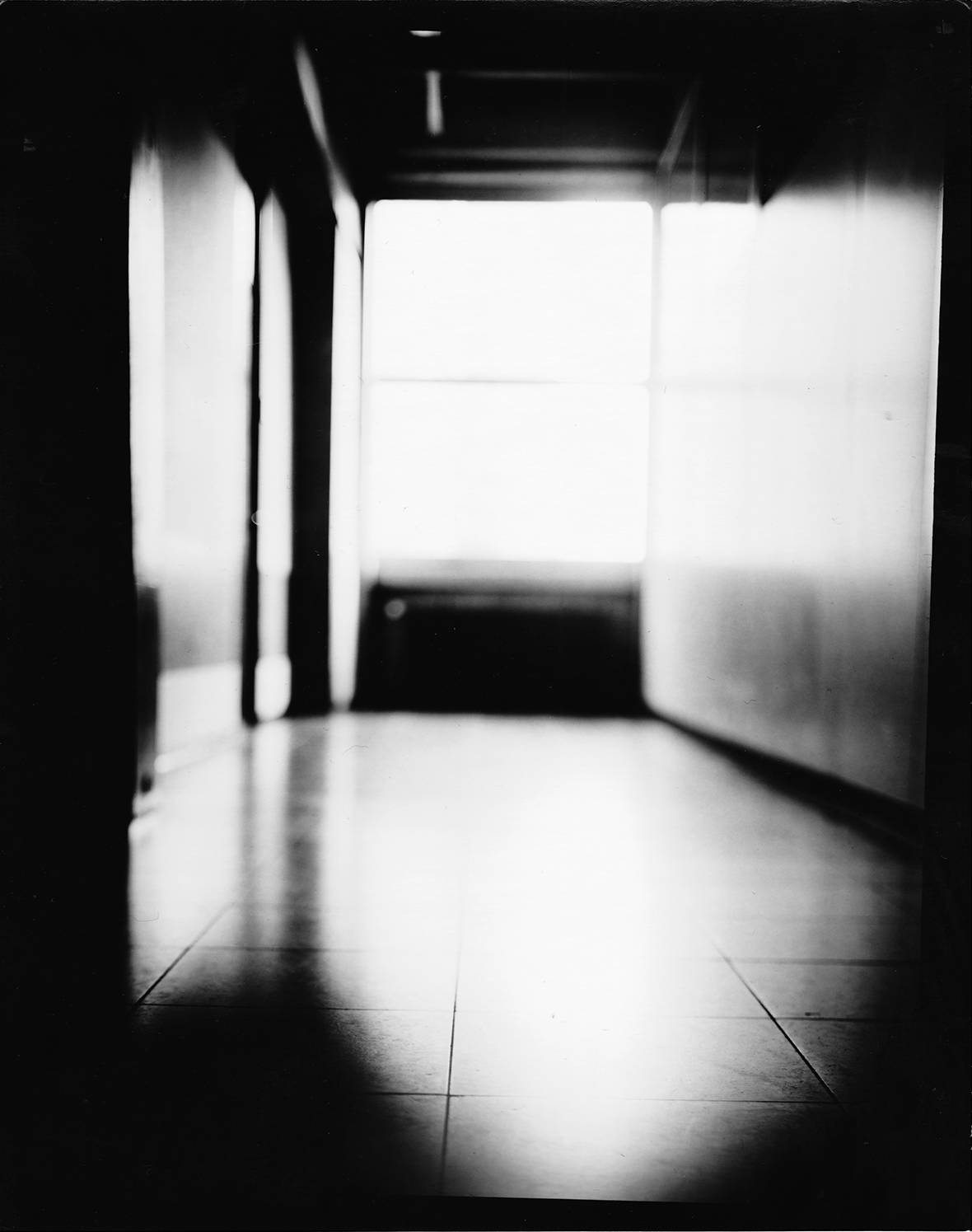 bright empty corridor in high contrast analog black and white