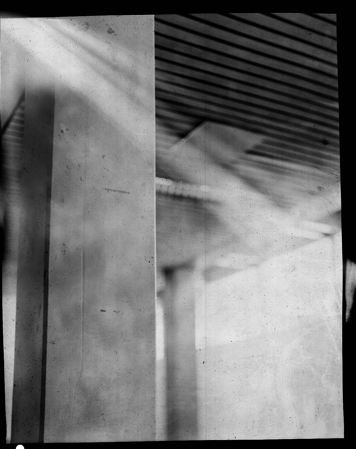 concrete column inside a building in high contrast analog black and white
