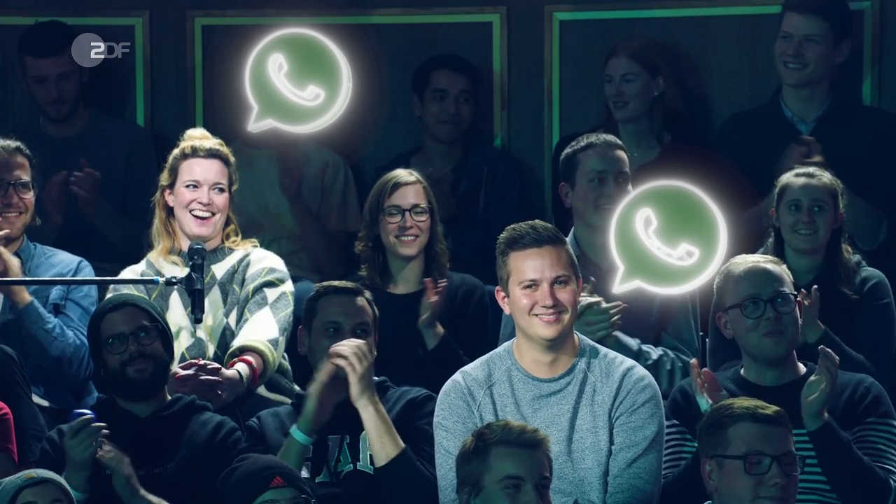 Two people in TV studio audience with AR 'Whats-app'-Logos over their heads